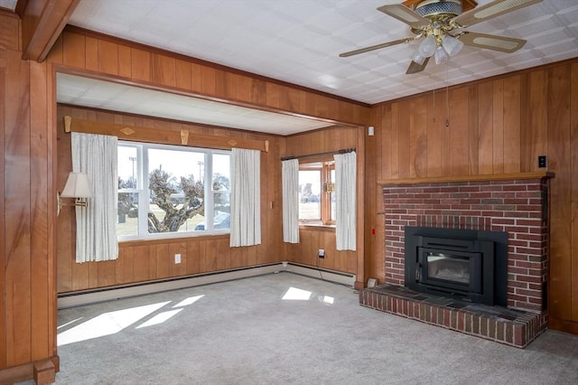 unfurnished living room with carpet flooring, wood walls, and a brick fireplace