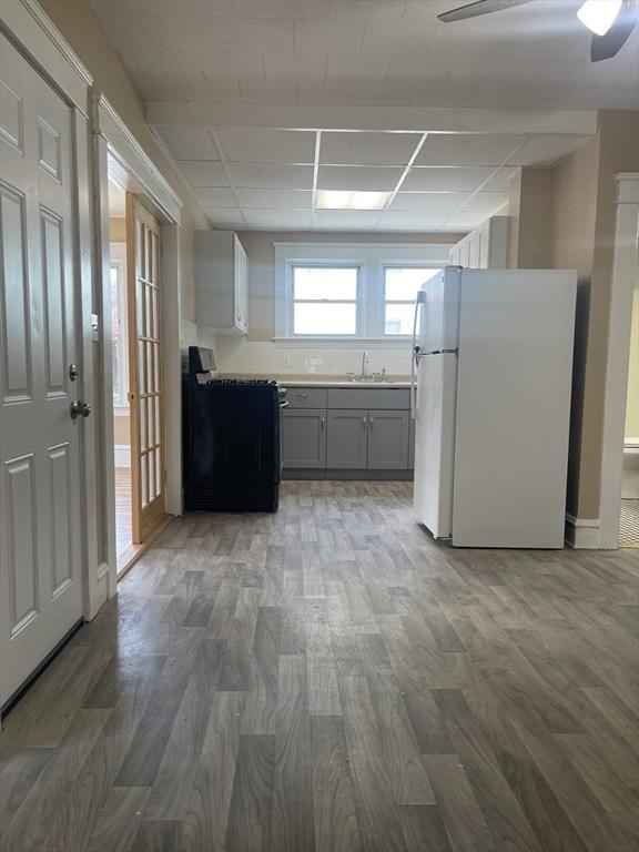 466-470 Cambridge St, Fall River, MA 02721 - kitchen featuring freestanding refrigerator, gray cabinetry, stove, and wood finished floors