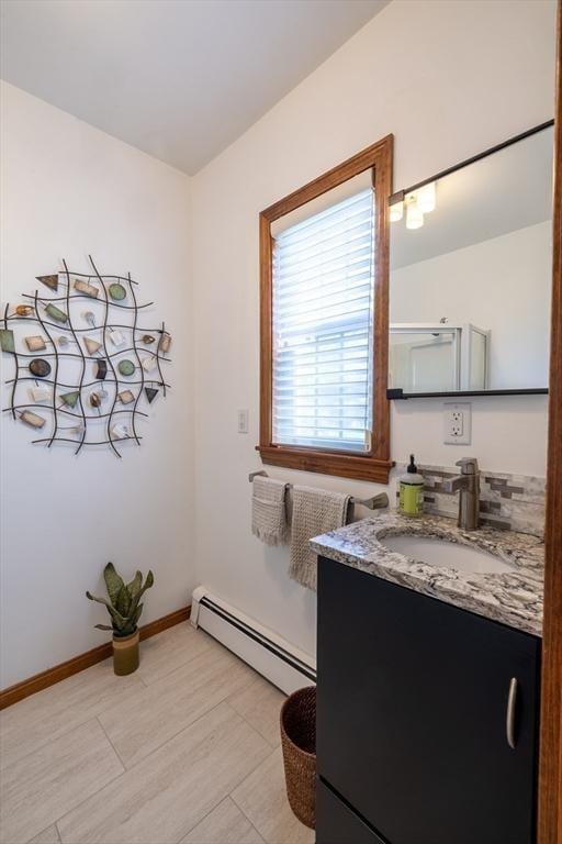 4 Fall St, Malden, MA 02148 - bathroom featuring baseboard heating, vanity, and baseboards