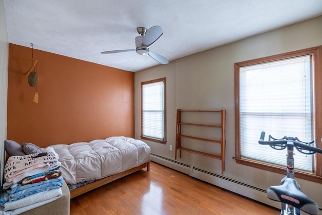 4 Fall St, Malden, MA 02148 - bedroom featuring a baseboard radiator, wood finished floors, and a ceiling fan
