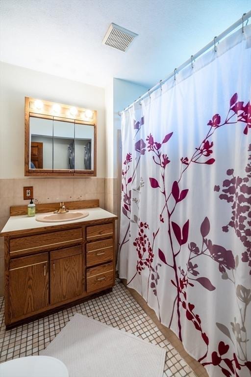 4 Fall St, Malden, MA 02148 - full bathroom featuring vanity, tile walls, and curtained shower