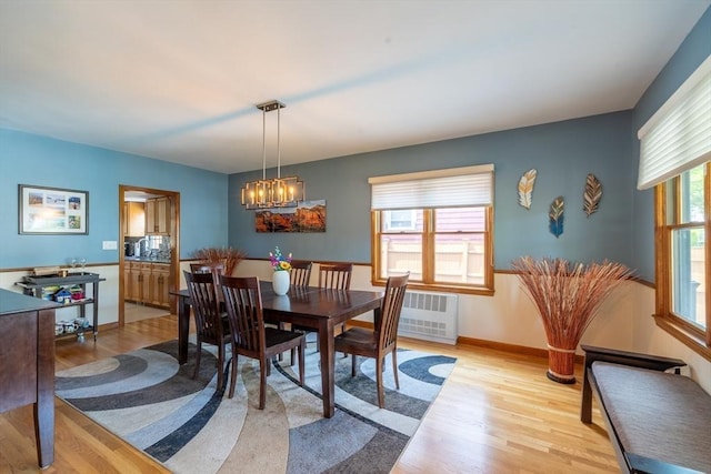 4 Fall St, Malden, MA 02148 - dining area featuring light wood-style floors, a chandelier, radiator heating unit, and baseboards