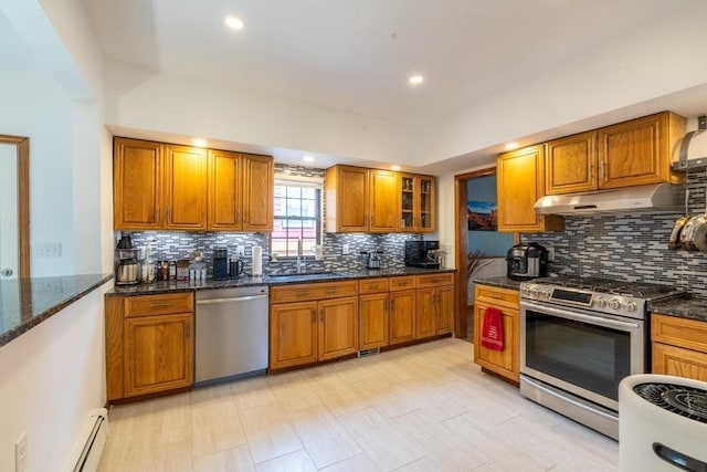 4 Fall St, Malden, MA 02148 - kitchen with stainless steel appliances, under cabinet range hood, a sink, brown cabinetry, and tasteful backsplash