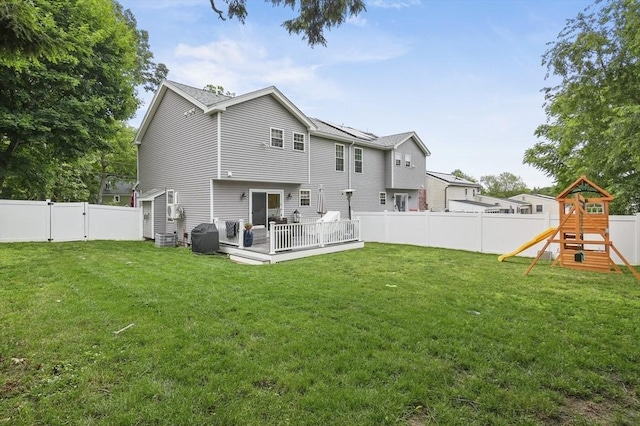 116 Pilgrim Rd Unit 116, Haverhill, MA 01832 - back of property with a fenced backyard, a wooden deck, a playground, and a gate