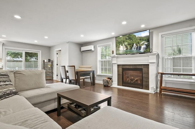 116 Pilgrim Rd Unit 116, Haverhill, MA 01832 - living room with an AC wall unit, recessed lighting, wood finished floors, healthy amount of natural light, and a fireplace