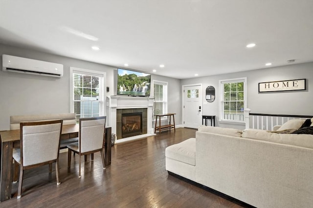 116 Pilgrim Rd Unit 116, Haverhill, MA 01832 - living area featuring a wall mounted air conditioner, dark wood-style floors, a tiled fireplace, and recessed lighting