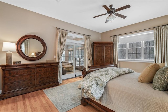 bedroom with multiple windows, access to outside, light hardwood / wood-style floors, and ceiling fan