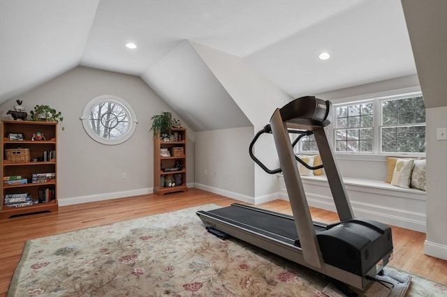 workout area featuring wood-type flooring and vaulted ceiling