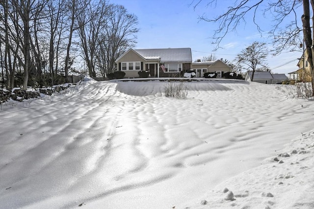 view of snow covered back of property