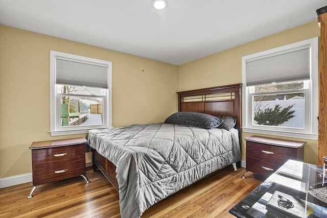 bedroom featuring wood finished floors and baseboards