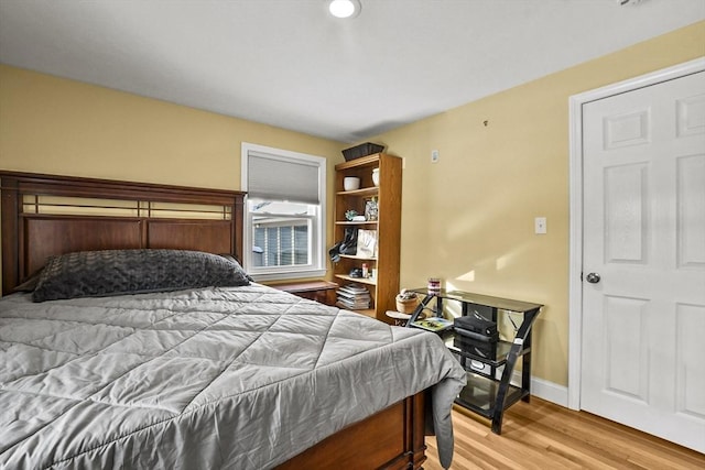 bedroom featuring baseboards and wood finished floors