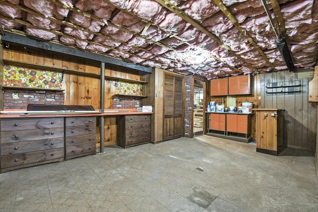 unfinished basement featuring wooden walls and a workshop area