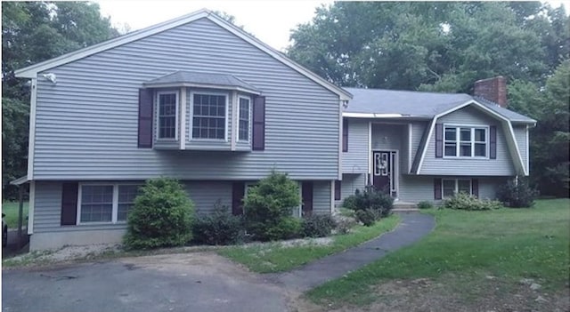 split foyer home with a front lawn