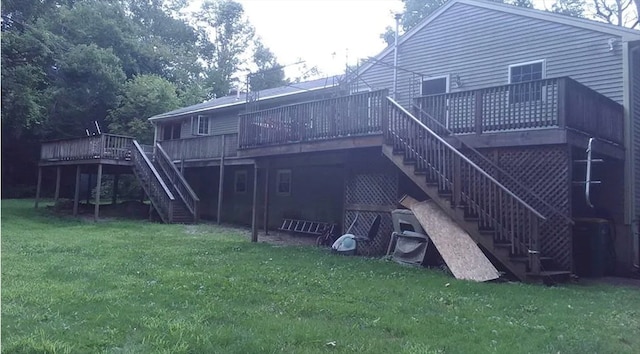 back of property with a deck and a yard