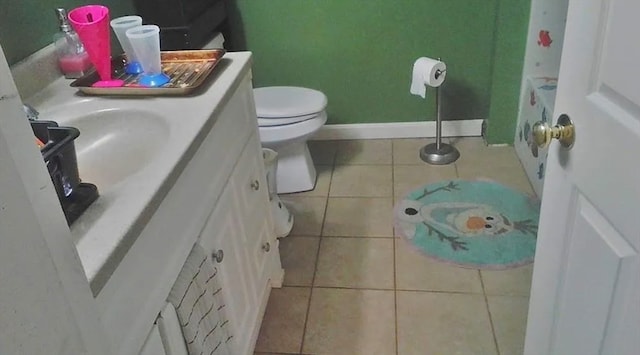 bathroom with vanity, tile patterned flooring, and toilet