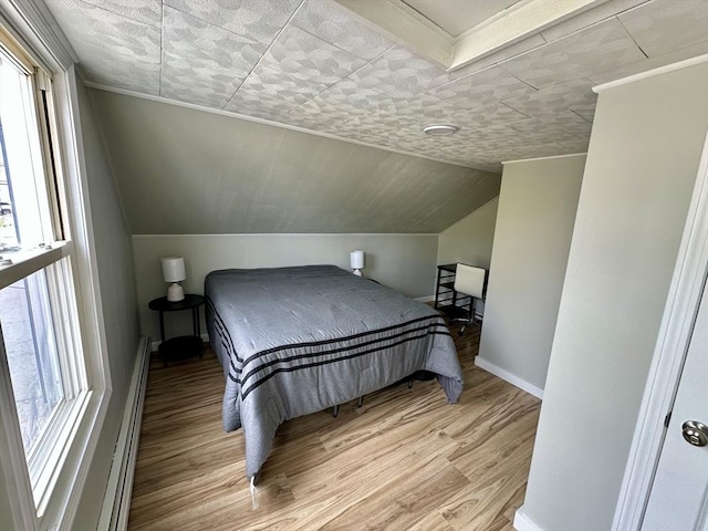 203 Division St, Fall River, MA 02721 - bedroom featuring multiple windows, light wood-style flooring, baseboards, a baseboard heating unit, and vaulted ceiling