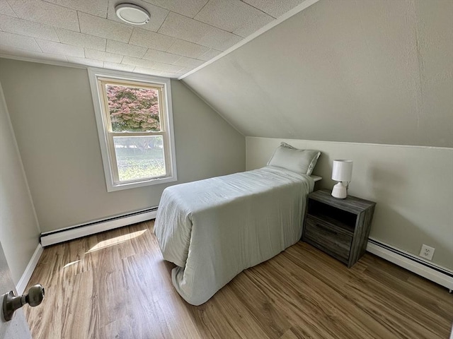 203 Division St, Fall River, MA 02721 - bedroom with baseboard heating, wood finished floors, lofted ceiling, and baseboards