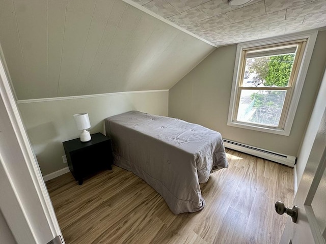 203 Division St, Fall River, MA 02721 - bedroom featuring a baseboard heating unit, wood finished floors, baseboards, and lofted ceiling