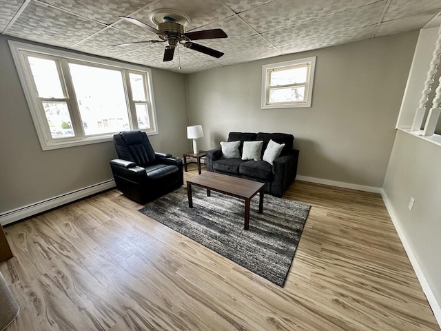203 Division St, Fall River, MA 02721 - living room featuring a baseboard radiator, ceiling fan, baseboards, and wood finished floors