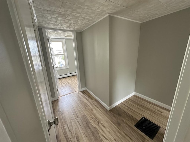 203 Division St, Fall River, MA 02721 - hall featuring a baseboard heating unit, wood finished floors, baseboards, and ornamental molding