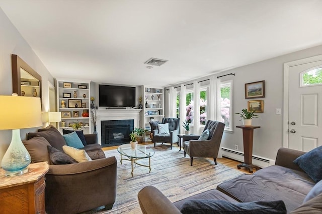 29 Day Ave, Hamilton, MA 01982 - living area featuring baseboard heating, a fireplace with flush hearth, wood finished floors, and built in shelves