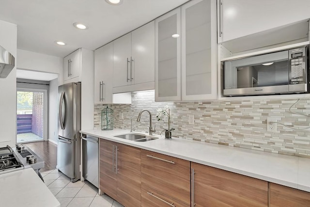 kitchen featuring a sink, appliances with stainless steel finishes, and light countertops