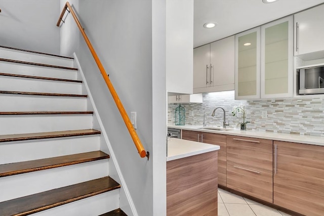 stairway with tile patterned flooring and recessed lighting
