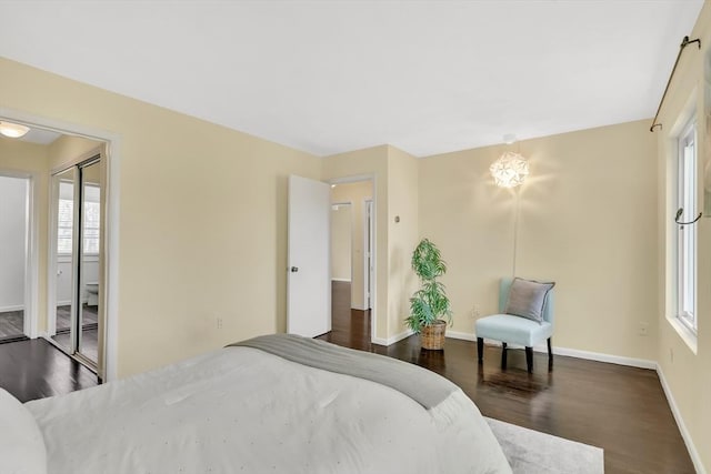 bedroom with baseboards and wood finished floors