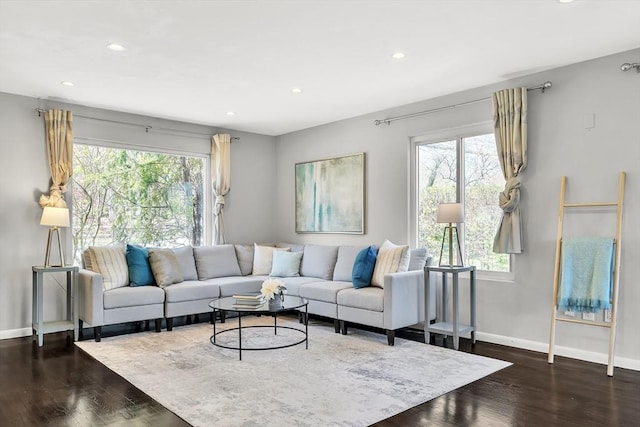 living room featuring recessed lighting, baseboards, and wood finished floors