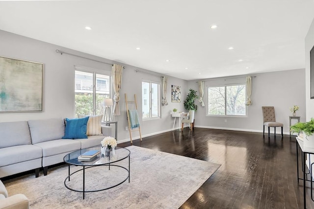 living area featuring baseboards, plenty of natural light, recessed lighting, and dark wood-type flooring