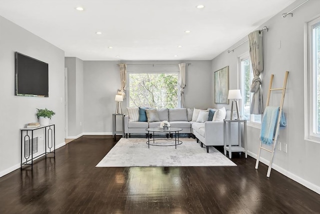 living area with recessed lighting, baseboards, and dark wood finished floors