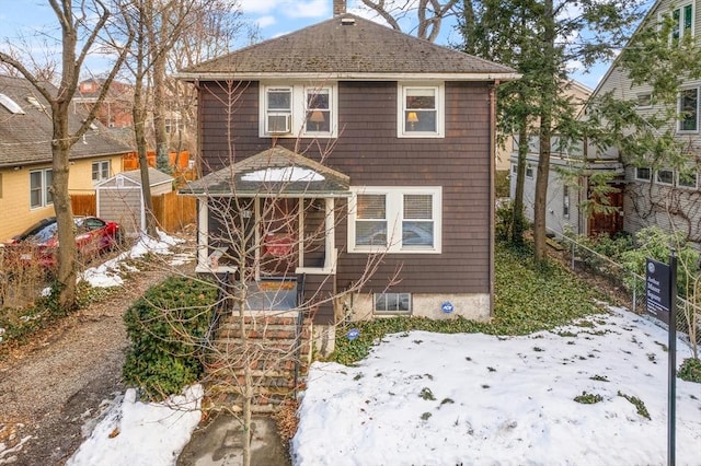 view of front of home featuring fence and a chimney