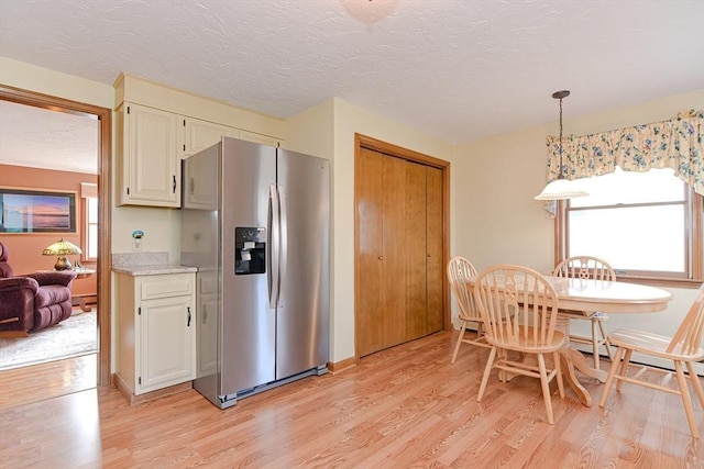 75 Columbus Ave Unit 75, Waltham, MA 02451 - kitchen with stainless steel refrigerator with ice dispenser, plenty of natural light, light wood finished floors, light countertops, and a textured ceiling