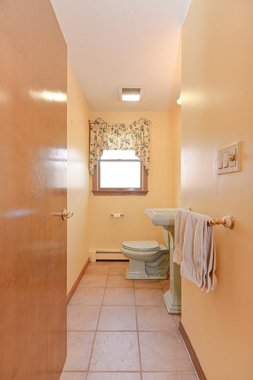 75 Columbus Ave Unit 75, Waltham, MA 02451 - half bath featuring a baseboard heating unit, toilet, baseboards, and tile patterned flooring