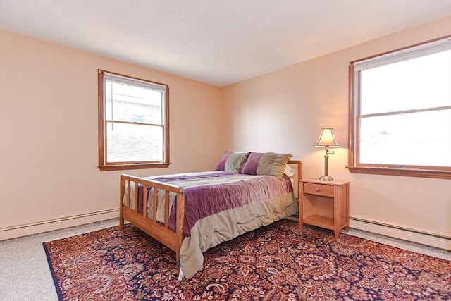 75 Columbus Ave Unit 75, Waltham, MA 02451 - carpeted bedroom featuring a baseboard heating unit, multiple windows, and baseboards