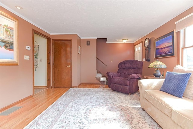 75 Columbus Ave Unit 75, Waltham, MA 02451 - living room with light wood-style floors, stairs, baseboards, and ornamental molding