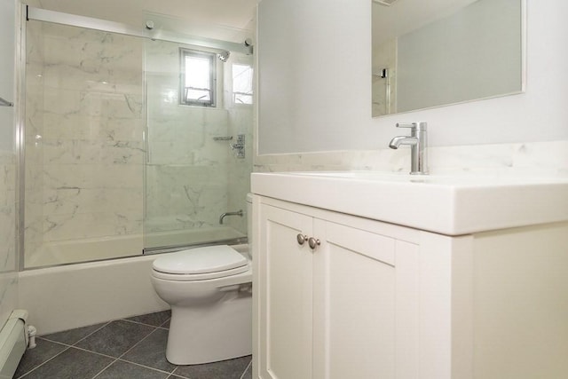 bathroom with vanity, shower / bath combination with glass door, tile patterned flooring, a baseboard heating unit, and toilet