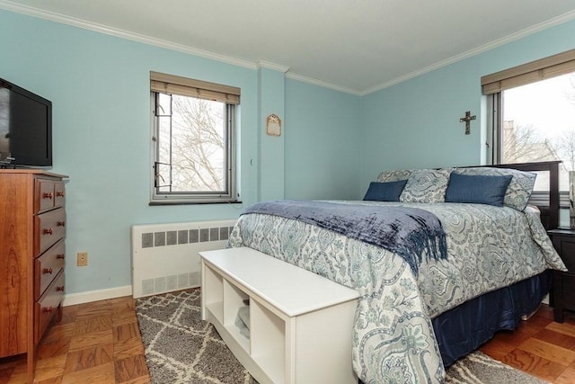 bedroom featuring multiple windows, radiator heating unit, and crown molding