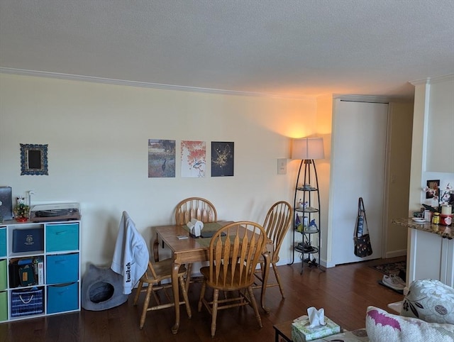 dining area with wood finished floors and a textured ceiling