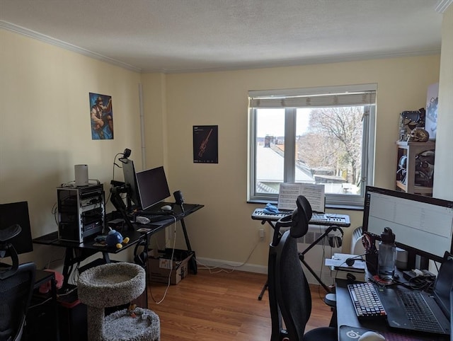 office space with baseboards, a textured ceiling, wood finished floors, and crown molding