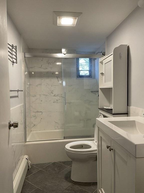 bathroom with toilet, tile patterned floors, combined bath / shower with glass door, vanity, and a baseboard radiator