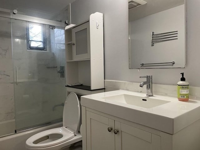 full bathroom featuring vanity, toilet, visible vents, and enclosed tub / shower combo