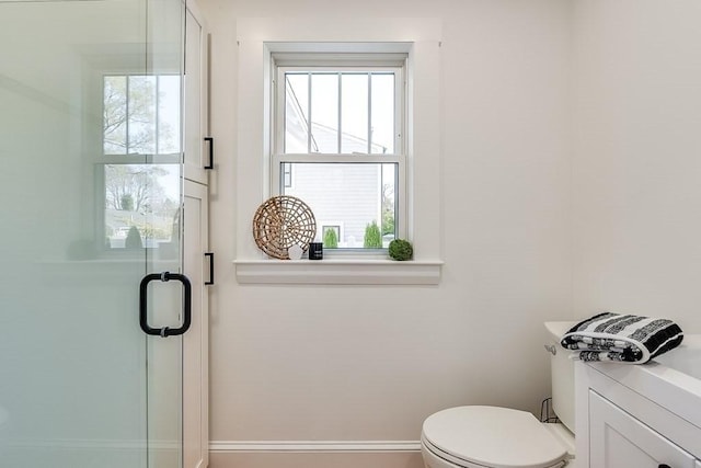 bathroom with a stall shower and toilet