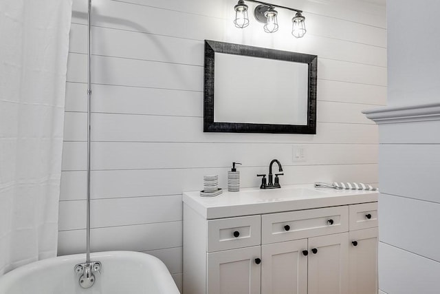 bathroom with vanity and a soaking tub