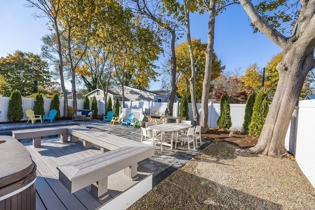 view of patio / terrace with a fenced backyard, a wooden deck, and outdoor dining space