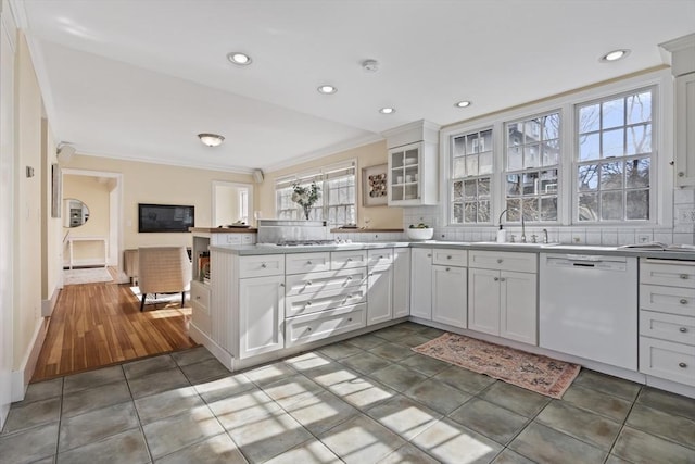 kitchen with backsplash, white cabinets, and white dishwasher