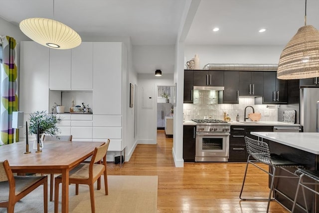 5 Mendell Way Unit 1, Boston, MA 02130 - kitchen with high end range, refrigerator, light countertops, hanging light fixtures, and decorative backsplash