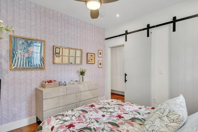 5 Mendell Way Unit 1, Boston, MA 02130 - bedroom with a barn door, wallpapered walls, wood finished floors, and a ceiling fan