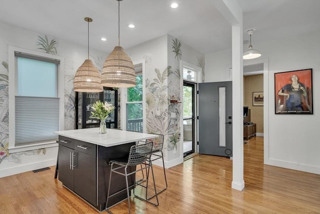 5 Mendell Way Unit 1, Boston, MA 02130 - kitchen featuring light wood-type flooring, light countertops, a kitchen island, pendant lighting, and a breakfast bar