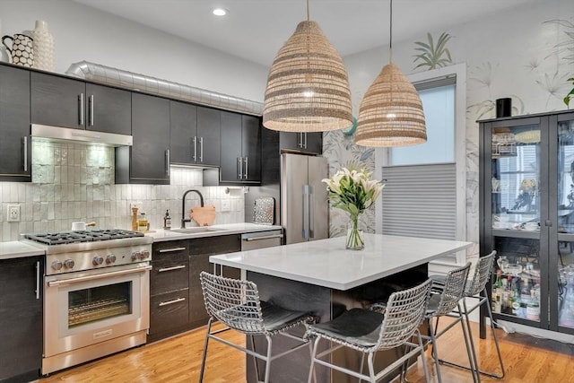 5 Mendell Way Unit 1, Boston, MA 02130 - kitchen with high quality appliances, a breakfast bar, light countertops, decorative light fixtures, and recessed lighting